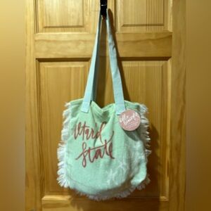 Alter’d State beach towel in bag.